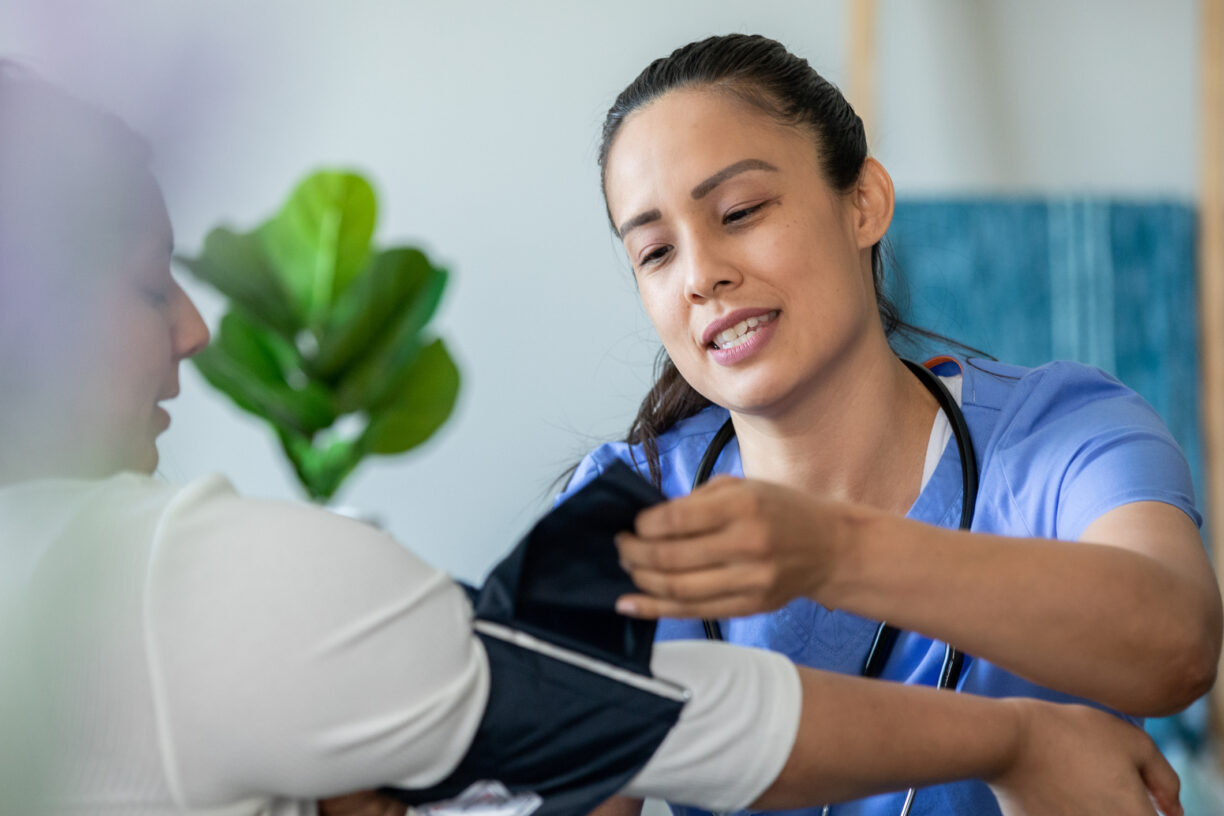 medical assistant checking her patients blood pressure