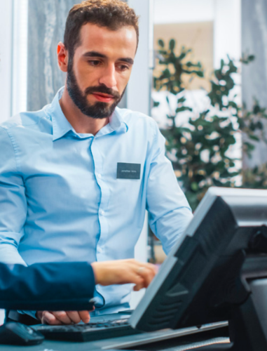 Retail operations training student working in store environment with instructor.