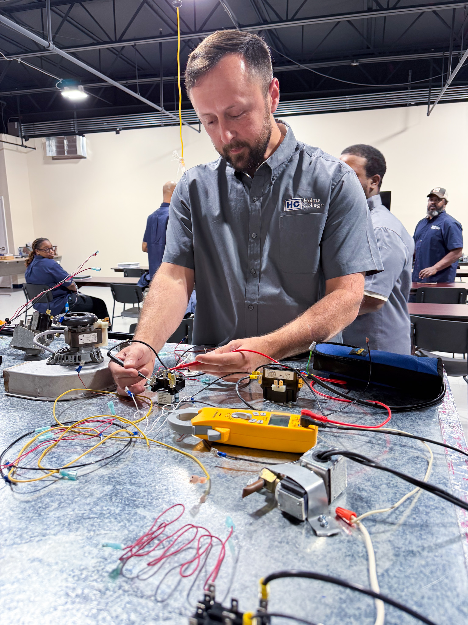 Electrical training program student works at Helms College