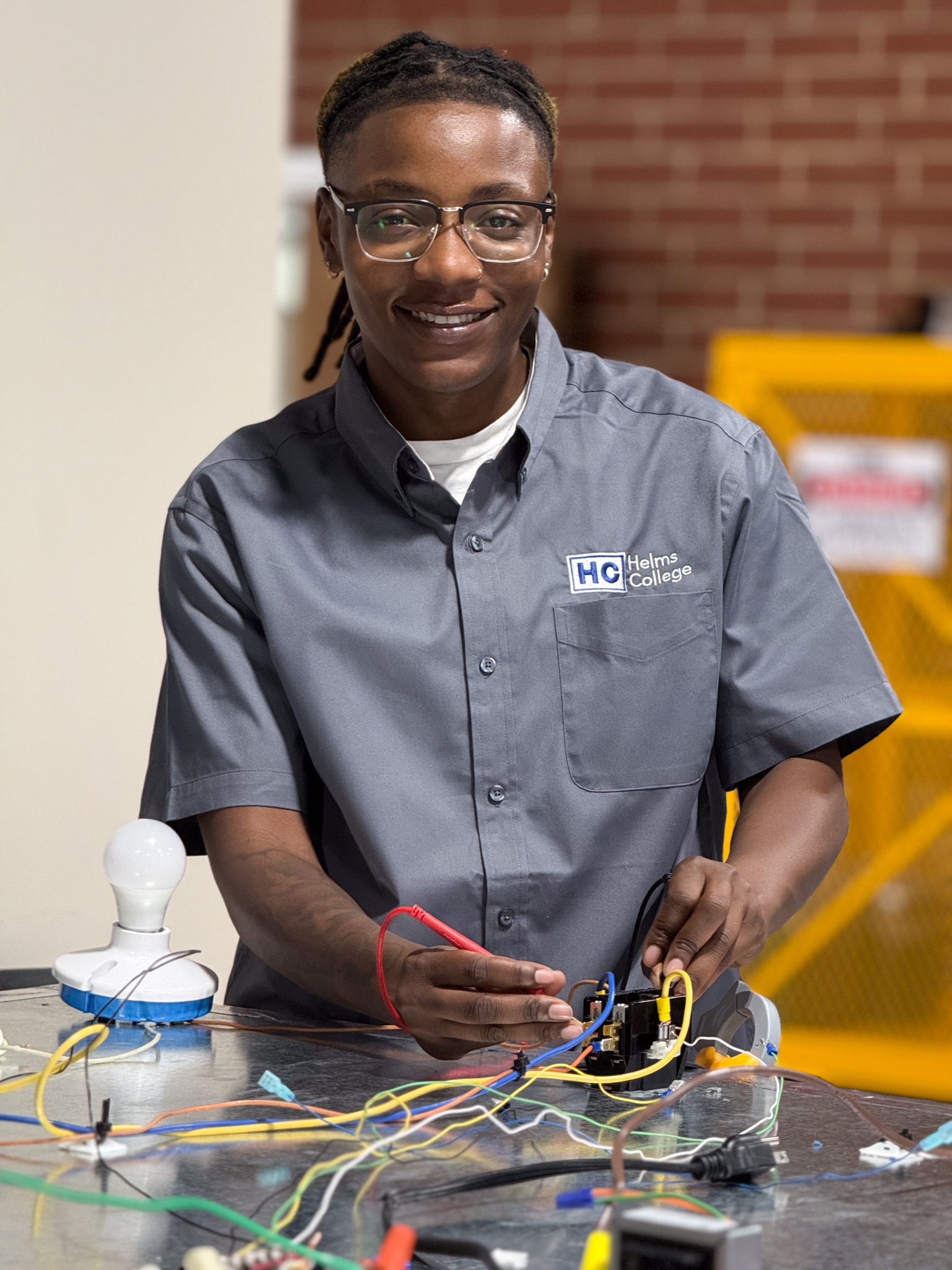 Electrical training program student works at Helms College
